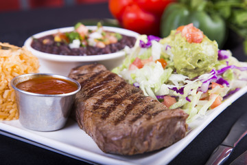 Medium rare steak with salad