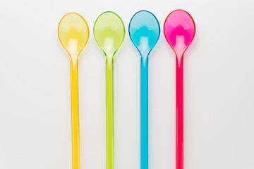 Color plastic swizzle sticks on white background