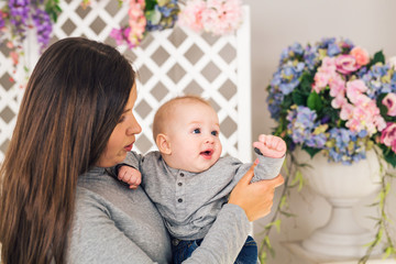 Close-up portrait of mother and baby boy son indoors