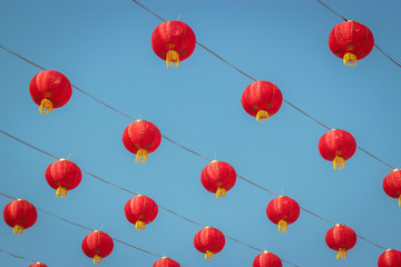 Chinese red paper lantern or lamp decoration as ceiling for Chinese New Year Festival. Blue sky.