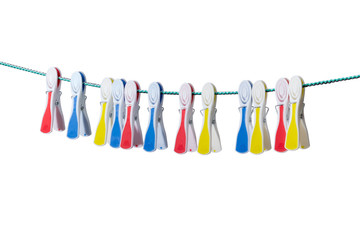 Varicolored plastic clothespins hanging on the clothes line