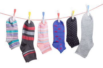 Different men's and women's socks on clothes line with clothespins
