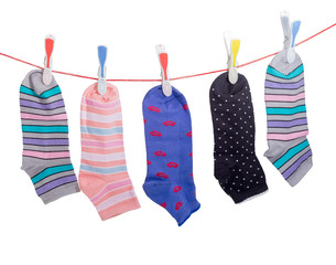 Different women's socks on the clothes line with clothespins