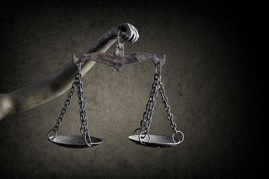 Lady Justice's hand holding Scale of Justice isolated on grunge background