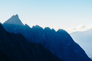 Fototapeta premium Colourful sunshine on a landscape of beautiful Fan Si Pan (Fansipan) or Phan Xi Pang mountain, the highest mountain in Indochina in Sapa, Hoang Lien National Park, Lao cai province northern Vietnam