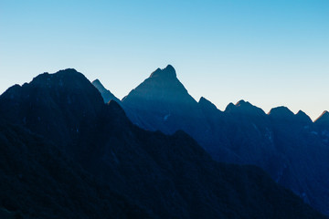 Fototapeta premium Colourful sunshine on a landscape of beautiful Fan Si Pan (Fansipan) or Phan Xi Pang mountain, the highest mountain in Indochina in Sapa, Hoang Lien National Park, Lao cai province northern Vietnam
