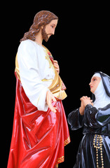 Statue of Jesus Christ and mary. Sacred Heart. Christianity symbol isolated on black background