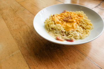 Noodle bacon with cheese on wood background..