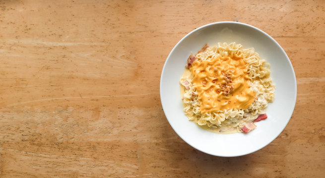 Noodle bacon with cheese on wood background..