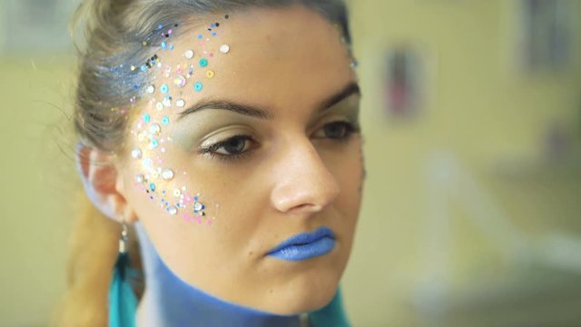 Make-up artist making bodyart of peahen for carnival and halloween for girl 4K