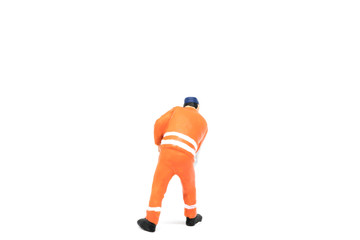 Miniature people worker wearing safety construction on white background with a space for text