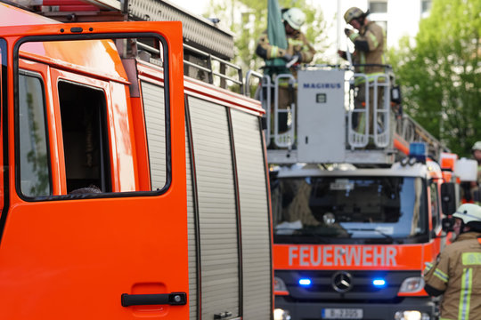 Berlin, Germany - April 30, 2017: fire department service truck and firemen. 112 is the single European emergency number that can be dialed free of charge is used for fire and medical emergency
