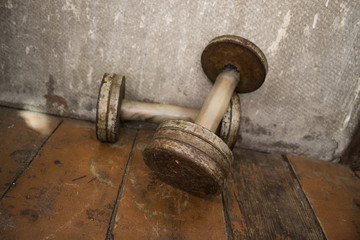 Old iron dumbbells, worn and with rust from time to time