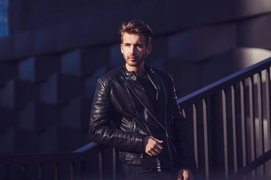 Portrait of a man in a leather jacket in urban style