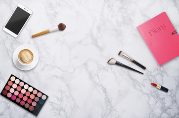 Fashion blogger workplace with make up and coffee