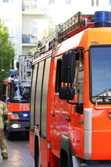 Fototapeta premium Berlin, Germany - April 30, 2017: fire department service truck and firemen. 112 is the single European emergency number that can be dialed free of charge is used for fire and medical emergency