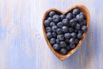 ripe sweet blueberries on wooden table