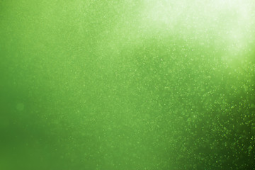 abstract of green light and glitter bokeh. image is blurred