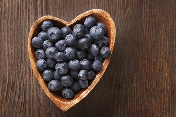 ripe sweet blueberries on wooden table