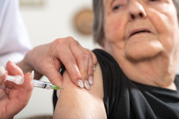 Senior woman getting an injection