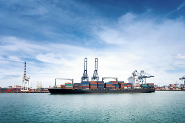 Logistics and transportation of International Container Cargo ship with ports crane bridge in...