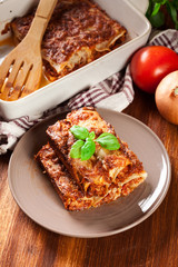 Baked cannelloni with minced meat and bechamel sauce on a plate
