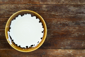 Top view of empty ceramic plate on wooden background with copy space..