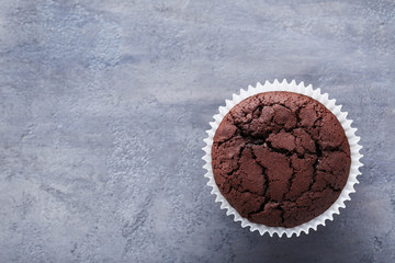Chocolate muffin on a grey wooden table