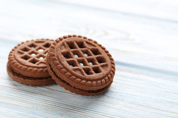 Chocolate cookies with cream on white wooden table
