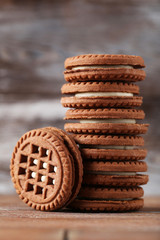 Chocolate cookies with cream on brown wooden table