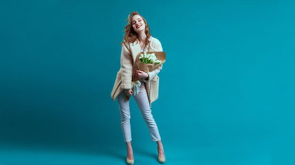 Stylish beautiful woman walking in street, wearing pink coat, purse, sunglasses, white shirt, fashion outfit, autumn trend, smiling happy, accessories