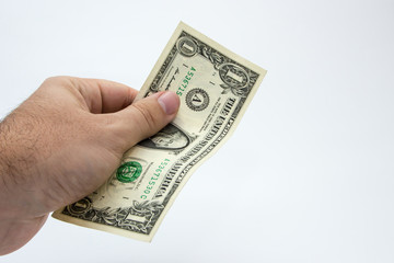 A close up photo of a Caucasian male hand holding a 1 dollar USA note 