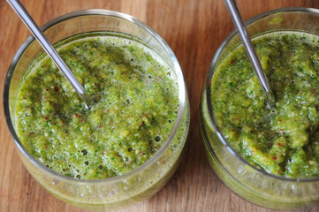 Green smoothies in glasses with spoons