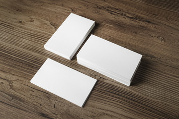 Mockup of three blank business cards stacks on wood table background. Blank template for your...
