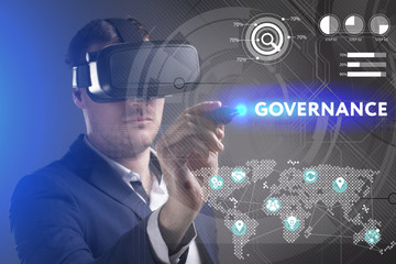 Business, Technology, Internet and network concept. Young businessman working in virtual reality glasses sees the inscription: Governance