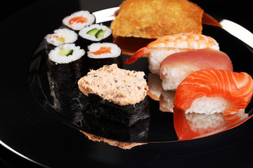 close up of sashimi sushi set with chopsticks and soy - sushi roll with salmon and sushi roll, delicious maki and nigiri