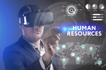 Business, Technology, Internet and network concept. Young businessman working in virtual reality glasses sees the inscription: Human resources