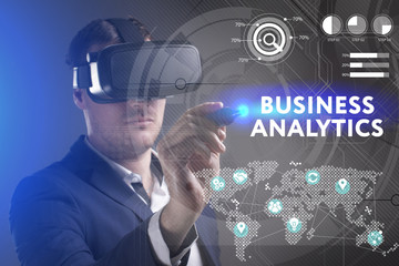 Business, Technology, Internet and network concept. Young businessman working in virtual reality glasses sees the inscription: Business analytics