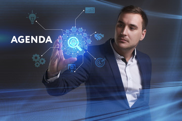 Business, Technology, Internet and network concept. Young businessman working on a virtual screen of the future and sees the inscription: Agenda