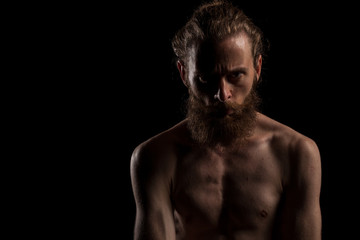 Fototapeta na wymiar Portrait of bearded cool hipster on black background in studio photo. Expression and fashion