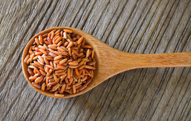 Brown rice  in wood spoon on table