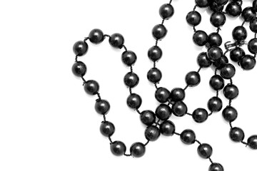 Black beads on a white background