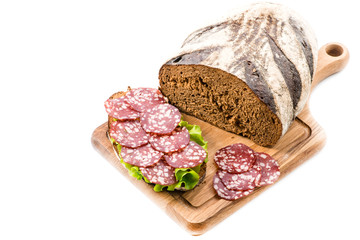 Bread and a sandwich with salami close-up