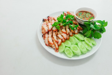  pork shoulder grill served with vegetable and sauce.