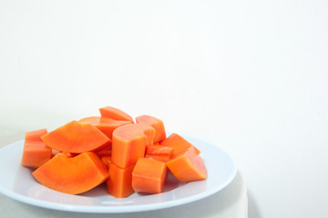 Papaya fruit is cooked in white dish.