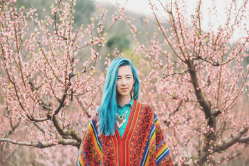 Beautiful woman walking among the flowering trees