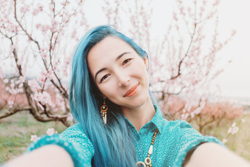 Girl taking selfie in spring garden.
