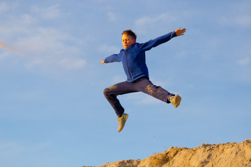 Teenager jumping against the sky. Parkour