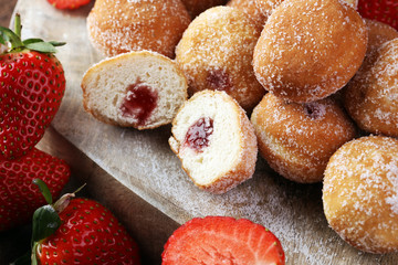 Bomboloni - traditional Italian doughnuts stuffed with strawberry jam