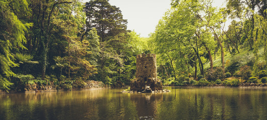 Castel tower in a lake at Park of Pena, Sintra, Portugal